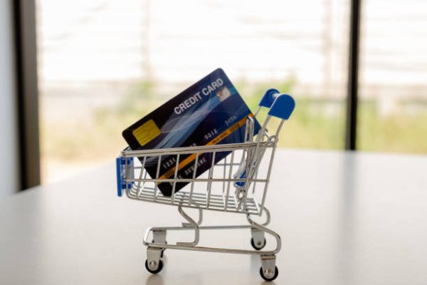 Credt card in cart on white table Online shopping ideas.