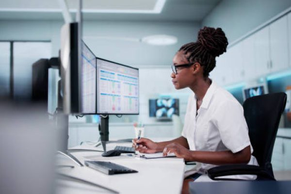 Hospital Doctor Using Spreadsheet For Billing Codes On Desktop