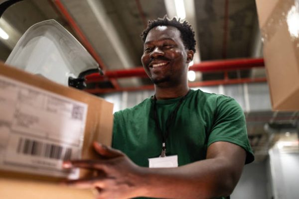 Postal worker losing his truck with packages preparing for delivery.